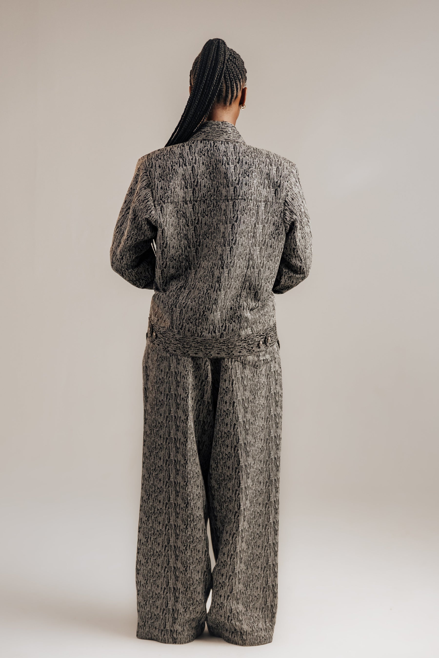 Person wearing a patterned outfit on a plain background