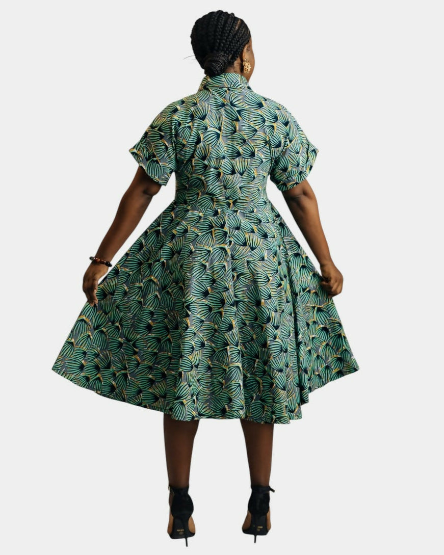Woman wearing a green patterned dress on a white background