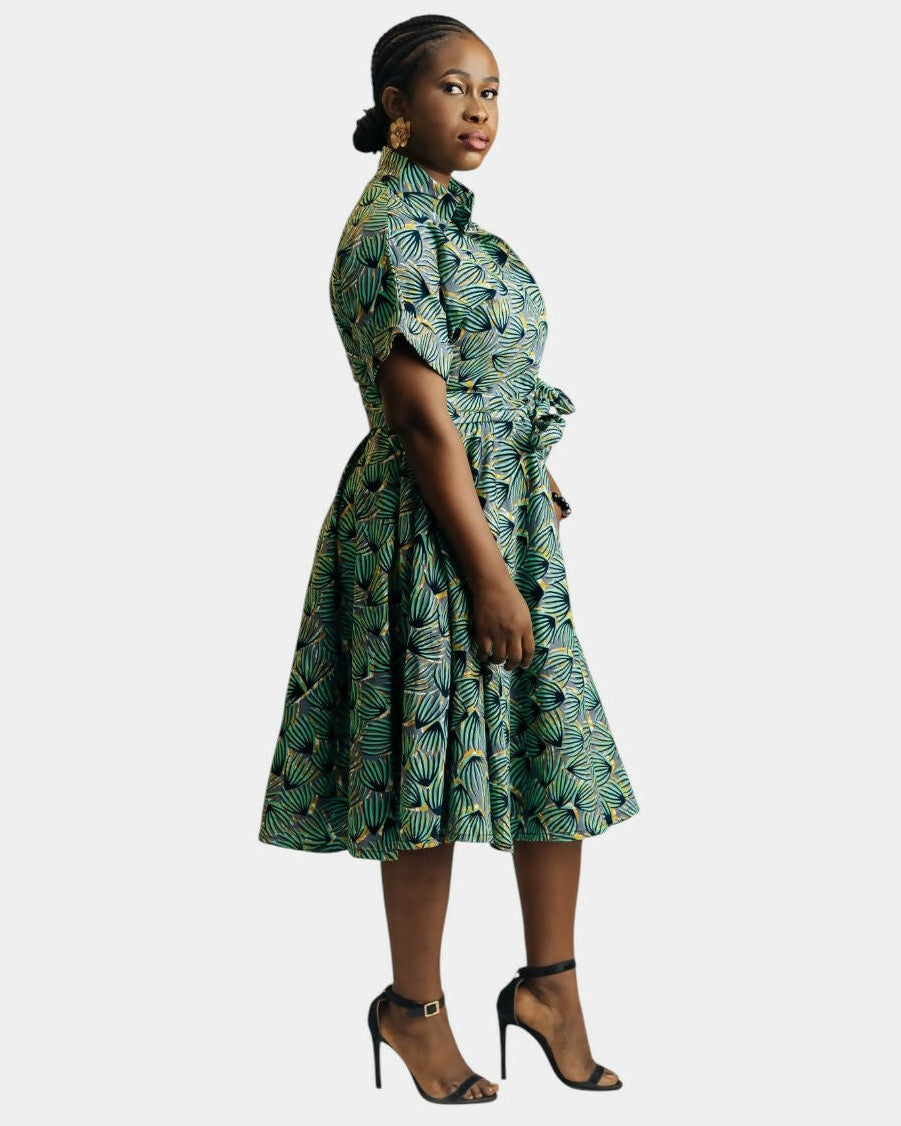 Woman wearing a green patterned dress on a white background