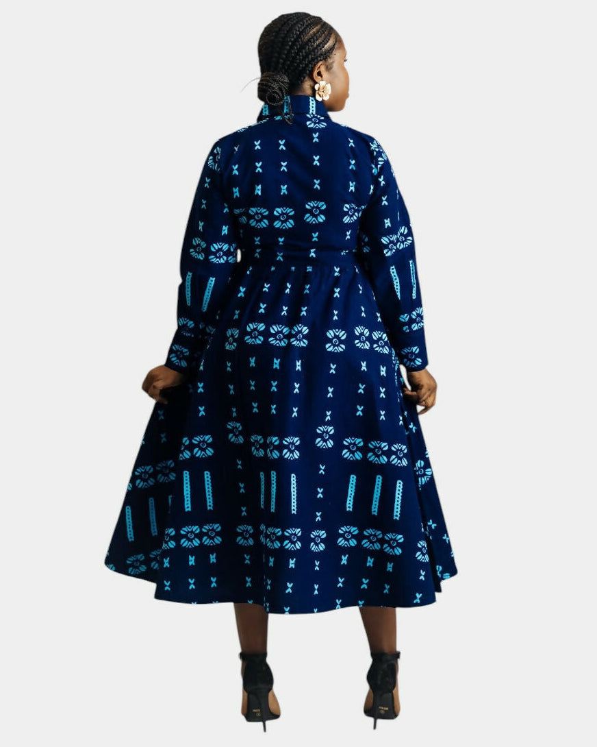 Woman wearing a blue patterned dress on a white background