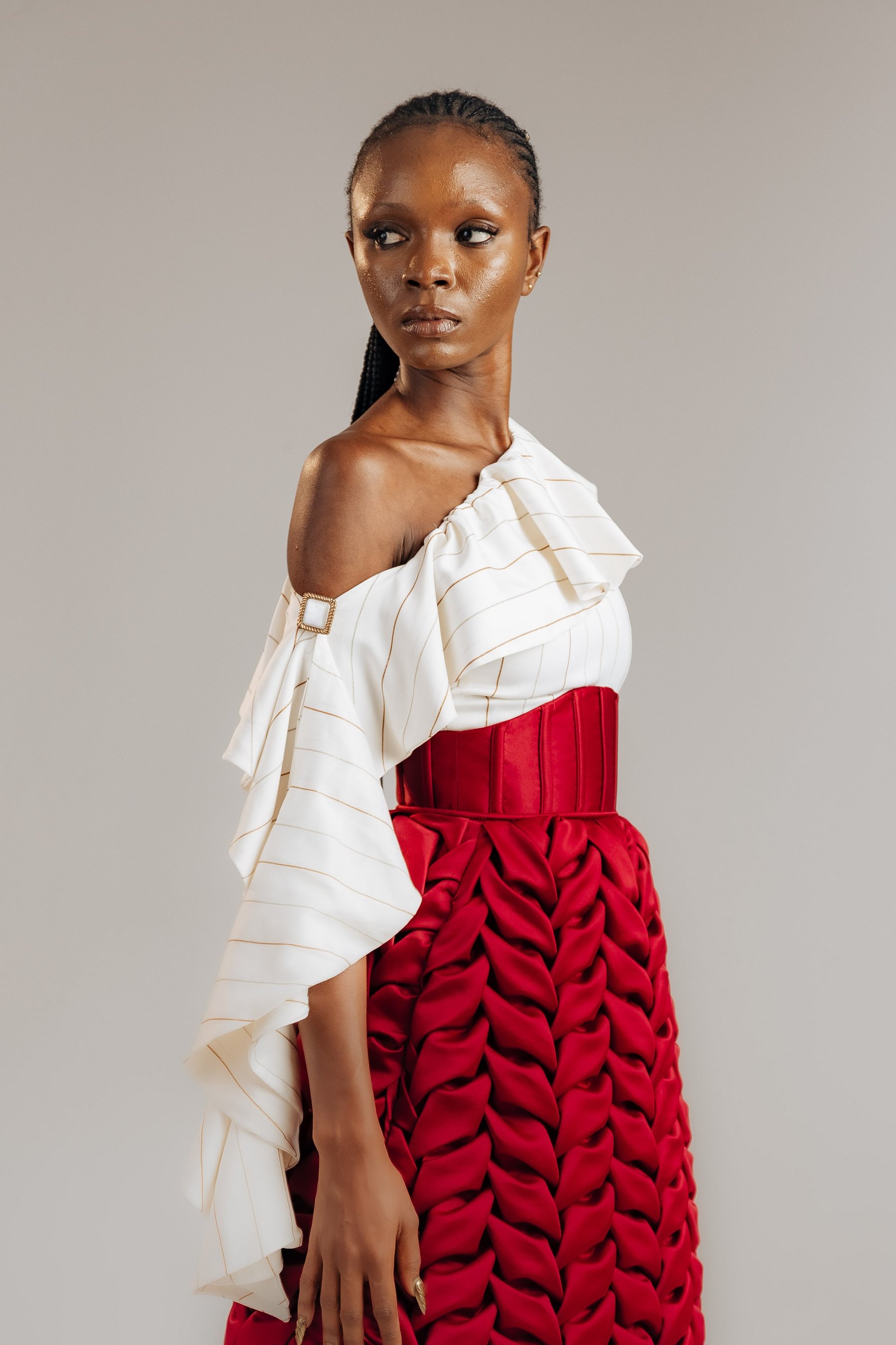 Woman wearing a red and white dress against a plain background