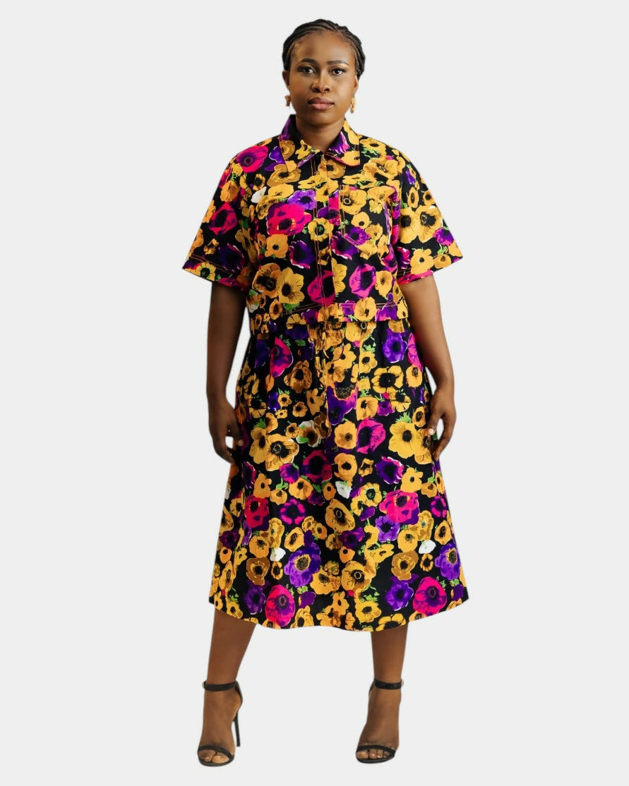 Woman wearing a colorful floral dress on a white background